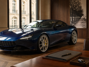 Grand tourisme italien bleu dans un showroom parisien avec dossier de vente