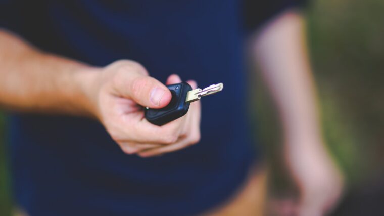 Une personne remet une clé automobile à une autre