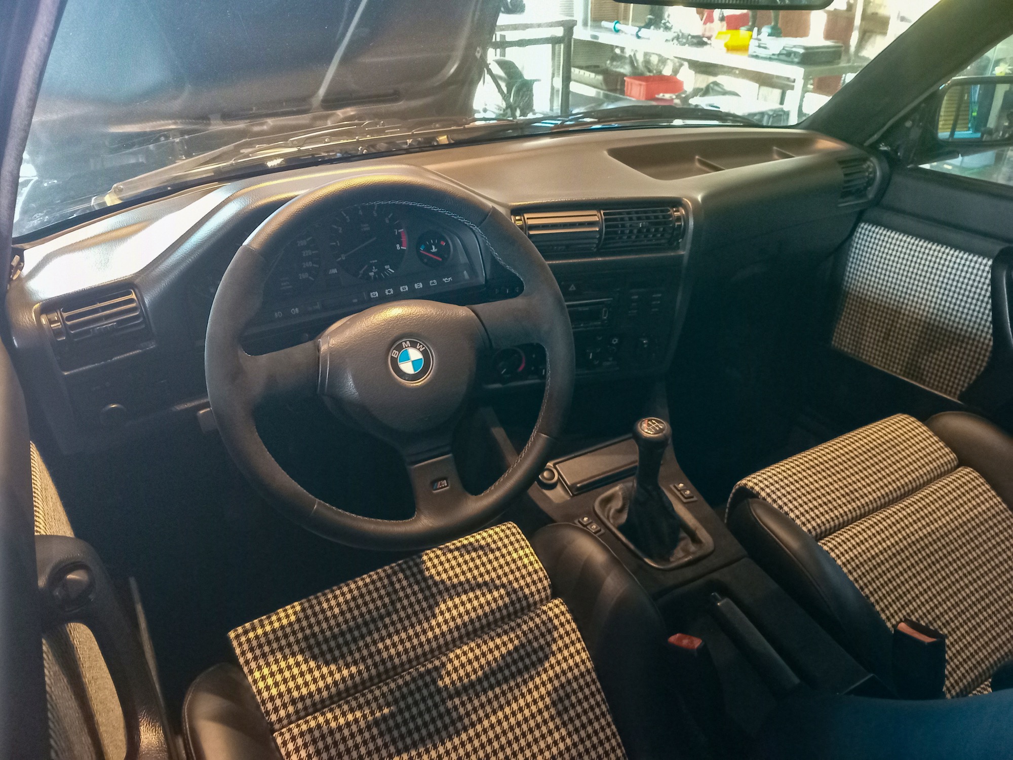 Habitacle d’une BMW M3 E30 avec volant et instrumentation d’époque