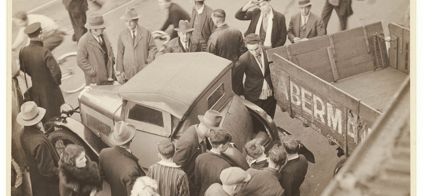 Automobile ancienne accidentée entourée de témoins et de policiers